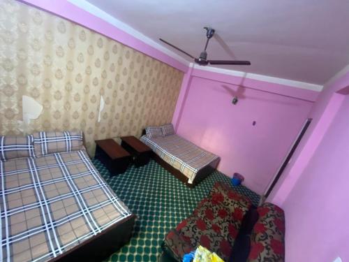 two beds in a room with pink walls at Hotel tulsi sagar Int'l pvt Ltd in Kathmandu