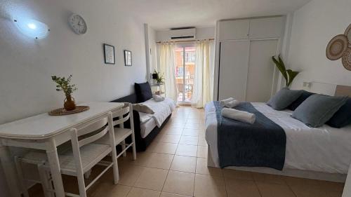 a bedroom with a bed and a table and a couch at Estudio Minerva 502 in Benalmádena