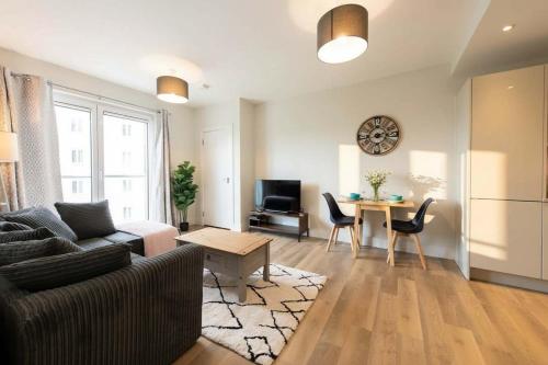 a living room with a couch and a table at Fantastic 1 Bed Apartment in Crawley in Crawley