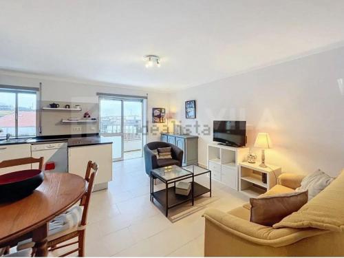 a living room with a couch and a table at Sunset Paradise in Caminha