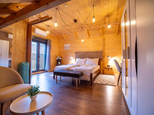 a bedroom with a bed in a room with wooden walls at Wooden Villa Old Oak Plitvice Lakes in Seliste Dreznicko