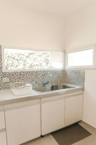 a kitchen with a sink and a window at Departamento LUNA NUEVA in Santa Clara del Mar