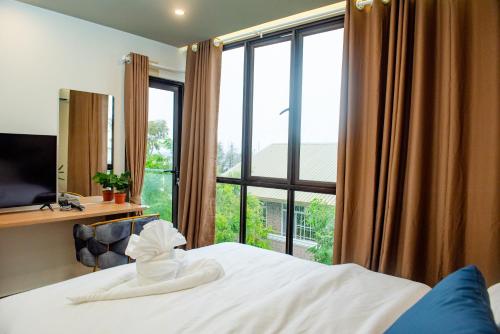 a bedroom with a bed and a large window at Reagal Garden in Hulhumale
