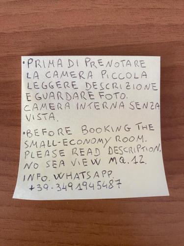 a piece of paper with handwriting on a table at B&B "La Vista Preziosa" Rooms in Gallipoli