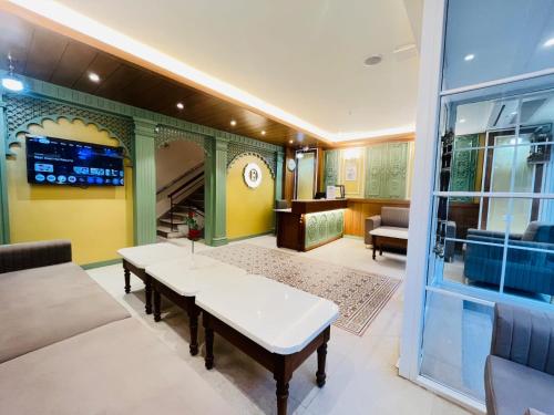 a living room with a table and a couch at Elegance Inn in Varanasi