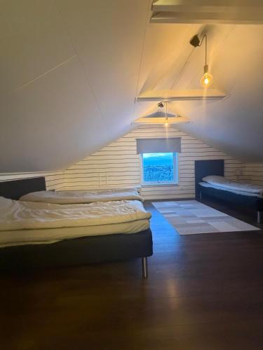 a room with two beds and a window at Aurora Apartment 7 in Kiruna