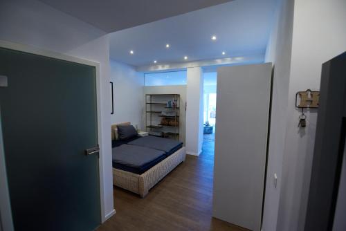 a bedroom with a bed and a room with a door at Business Apartments Höfle in Heppenheim an der Bergstrasse