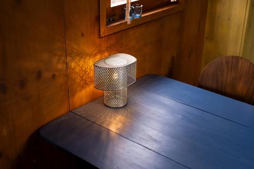 a table with a stool sitting on top of it at Tuiny House Noordwijk in Noordwijk