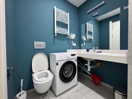 a blue bathroom with a washing machine in it at New Gudauri Studio N207 in Suites! in Gudauri