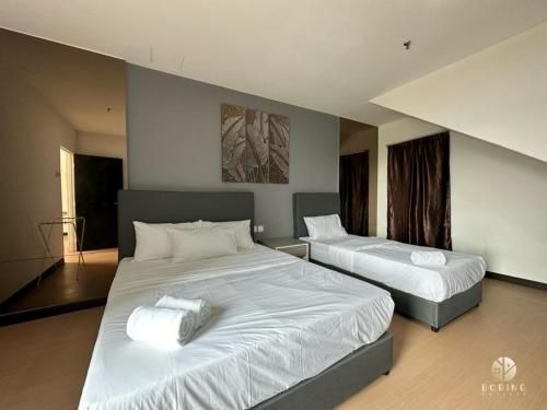 a bedroom with two beds with white sheets at Metra Square Ayer Keroh MITC in Ayer Keroh
