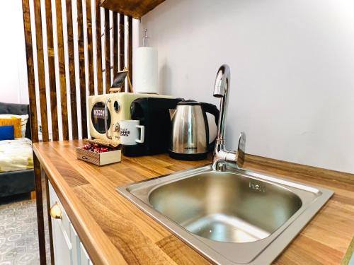 a kitchen counter with a sink and a coffee maker at Sweet cozy studio ultracentral in Cluj-Napoca
