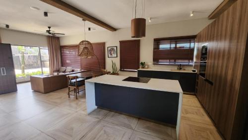 a kitchen with a island in the middle of a room at Beach House at Kokrobite in Kokrobite