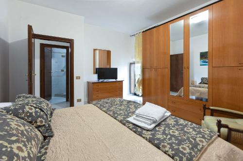 a bedroom with a bed and a dresser and a television at Al Rifugio Nel Borgo in Vitorchiano