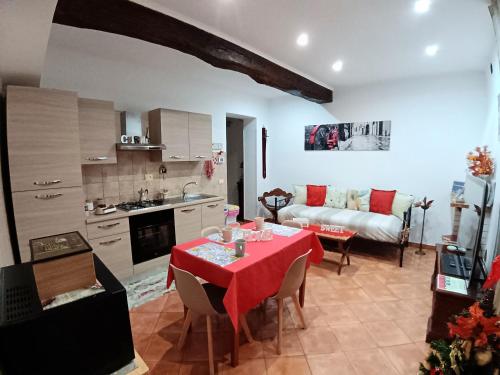a living room with a table with a red table cloth at La casa del Borgo Anagni in Anagni