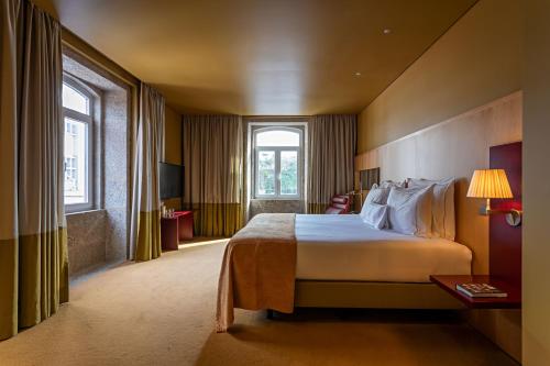 a hotel room with a large bed and a window at Pestana Palacio do Freixo, Pousada & National Monument - The Leading Hotels of the World in Porto