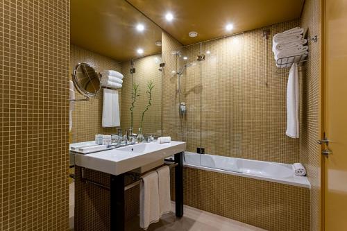 a bathroom with a sink and a bath tub at Pestana Palacio do Freixo, Pousada & National Monument - The Leading Hotels of the World in Porto