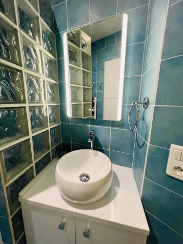 a bathroom with a white sink and a mirror at Ty Kéréon - Le cocon urbain in Quimper