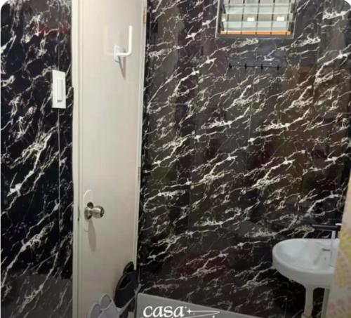 ein Badezimmer mit einer schwarzen Marmordusche mit Waschbecken in der Unterkunft Casa Garazi in Calo