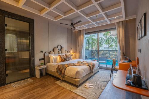 a bedroom with a large bed and a large window at SaffronStays Boudhi Tree Villas in Rishīkesh
