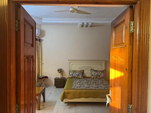 a bedroom with a bed and a ceiling at Musa house D ground in Faisalabad