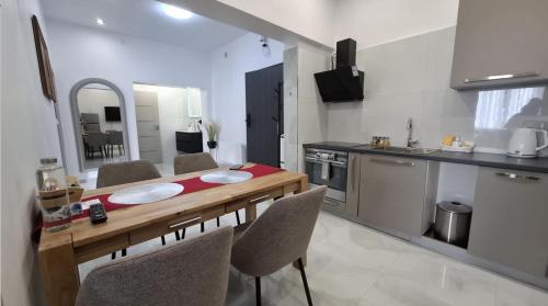 a kitchen with a table and some chairs in a room at Apartmány Farní in Moravská Třebová