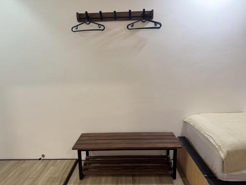 a bedroom with a bed and a wooden table at Zetta Roomstay in Kuala Lumpur
