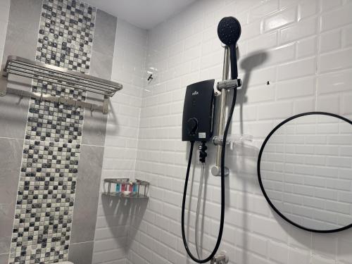 a shower with a shower head in a bathroom at Zetta Roomstay in Kuala Lumpur