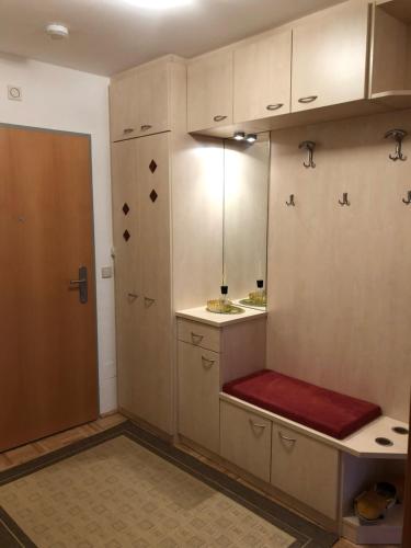 a room with a bench in a kitchen with cabinets at Sonnenalpe ckpk in Hermagor