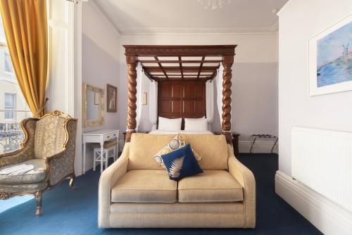 a bedroom with a chair and a bed with a canopy at INNit Blue Sky in Brighton & Hove
