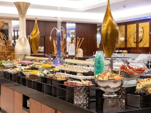 a buffet line with many different types of food at Swissotel Makkah in Makkah