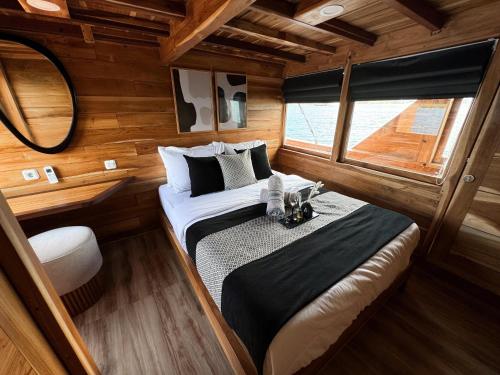 a bedroom with a bed in the middle of a boat at Shared Boat Komodo 3 days 2 Night in Komodo Labuan Bajo Airport