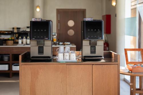 two microwaves sitting on top of a counter at Ibis Valencia Alfafar in Alfafar