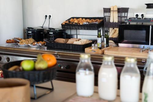 a kitchen with a counter with bottles of milk at Ibis Valencia Alfafar in Alfafar