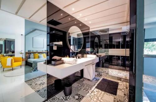 a bathroom with a sink and a living room at Appartement luxe hivernage in Marrakesh