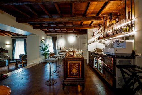 a living room with a bar with stools in it at Locanda Sibilla Luxury Suites in Tivoli