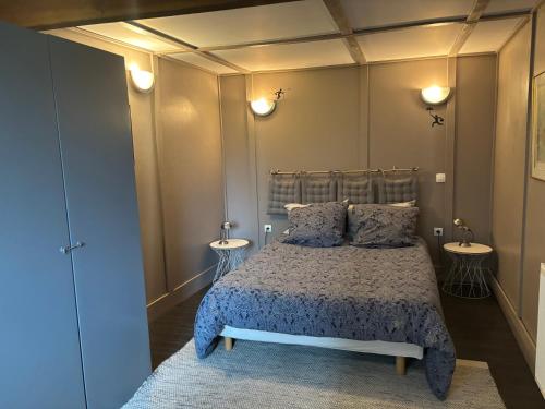 een slaapkamer met een bed en twee nachtkastjes bij Le phœnix in Linars