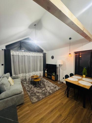 a living room with a couch and a table at Zakątek Ldzań in Ldzań