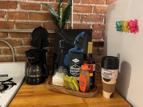 a kitchen counter with a bottle of wine and spices at Boston Edison Cozy Gallery Studio in Detroit