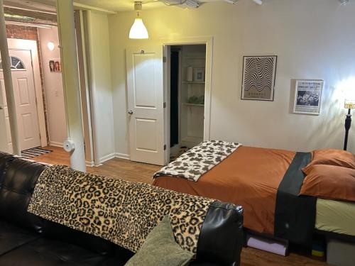 a living room with two beds and a couch at Boston Edison Cozy Gallery Studio in Detroit