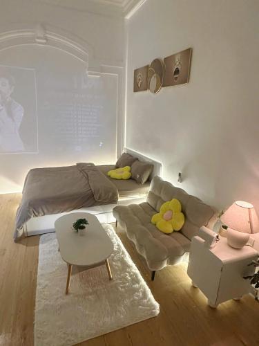 a living room with a bed and a couch at HuếDuo Homestay in Thôn Trường Giang