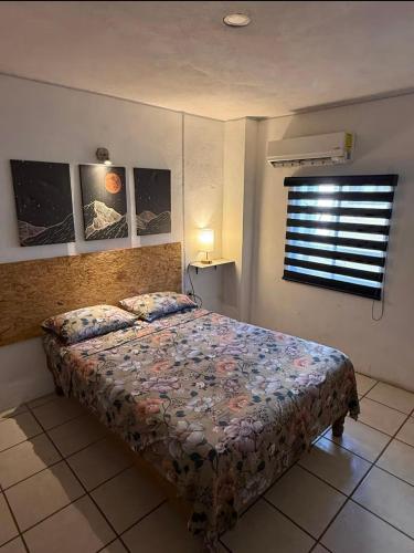 a bedroom with a bed and a window at Laguna 02 in Tampico