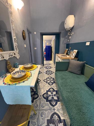 a living room with a couch and a table at Palazzo Rubina - Dimora mediterranea & SPA in Torre del Greco