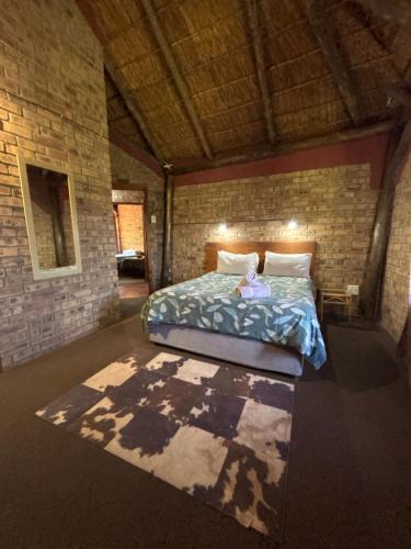 a small child sitting on a bed in a room at Inyala Game Lodge in Ventersdorp