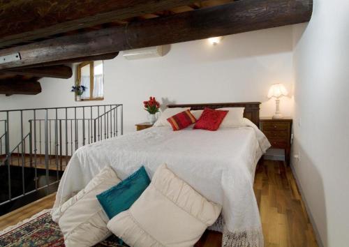 a bedroom with a large white bed with pillows at Accademia Residence in Prato