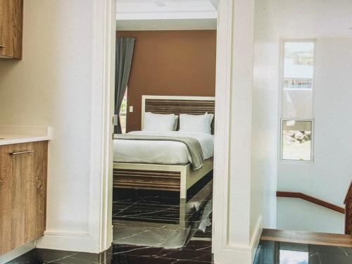 a bedroom with a bed in a room with a mirror at Spectacular views Atlantic Ocean in Basseterre