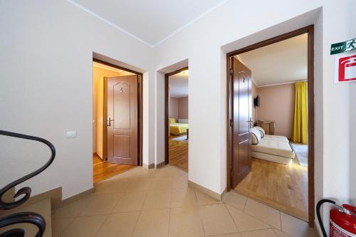 a corridor of a hotel room with two doors at Casa la Martin in Comarnic