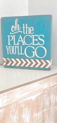 a blue sign that reads at the places youll go at Villa Mare in Teguise