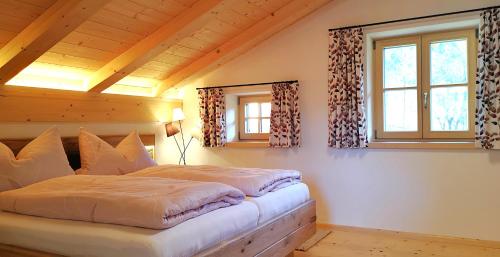 a bedroom with a large bed in a attic at Alpenchalet-Chiemgau in Marquartstein