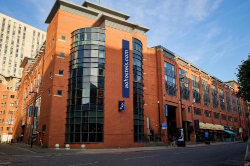 a red brick building with a sign on it at a&o Manchester City Centre in Manchester