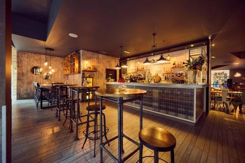 a restaurant with tables and chairs and a bar at a&o Manchester City Centre in Manchester
